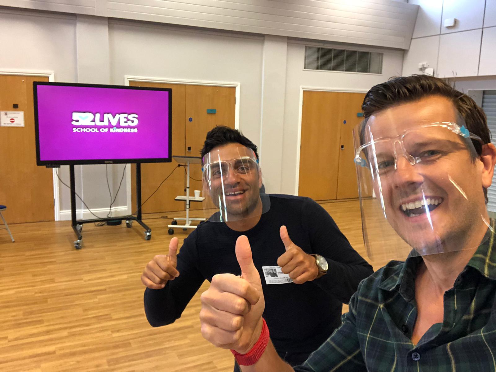Krish and a colleague giving thumbs up in a kindness workshop